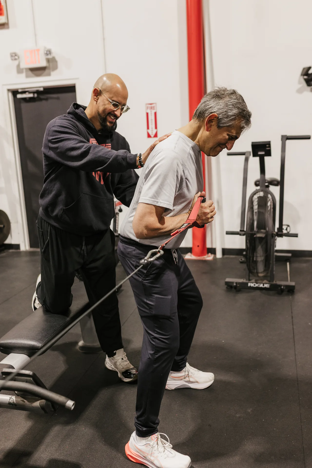Coach guiding a member through resistance-band training